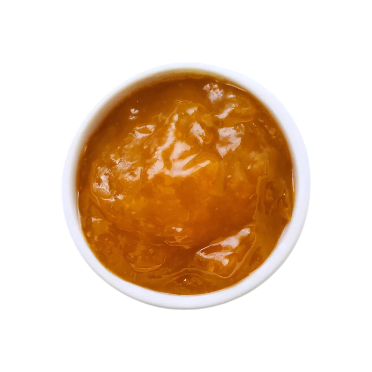 Vue rapprochée de la confiture de mangue M'AMOUR dans un bol blanc, texture onctueuse et brillante, riche en fruits tropicaux sucrés.